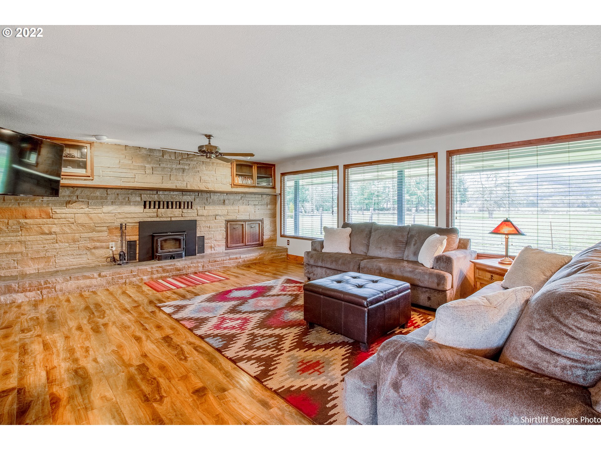 90818 Marcola Road Springfield, OR 97478 - Photo 7 of 32 a living room with furniture a fireplace and a flat screen tv