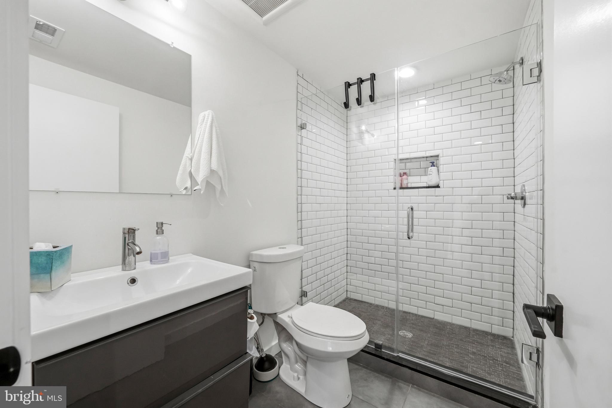 2604 Reed Street Philadelphia, PA 19146 - Photo 37 of 45 a bathroom with a sink a toilet and shower