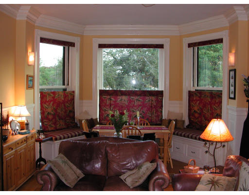 a living room with furniture and a lamp