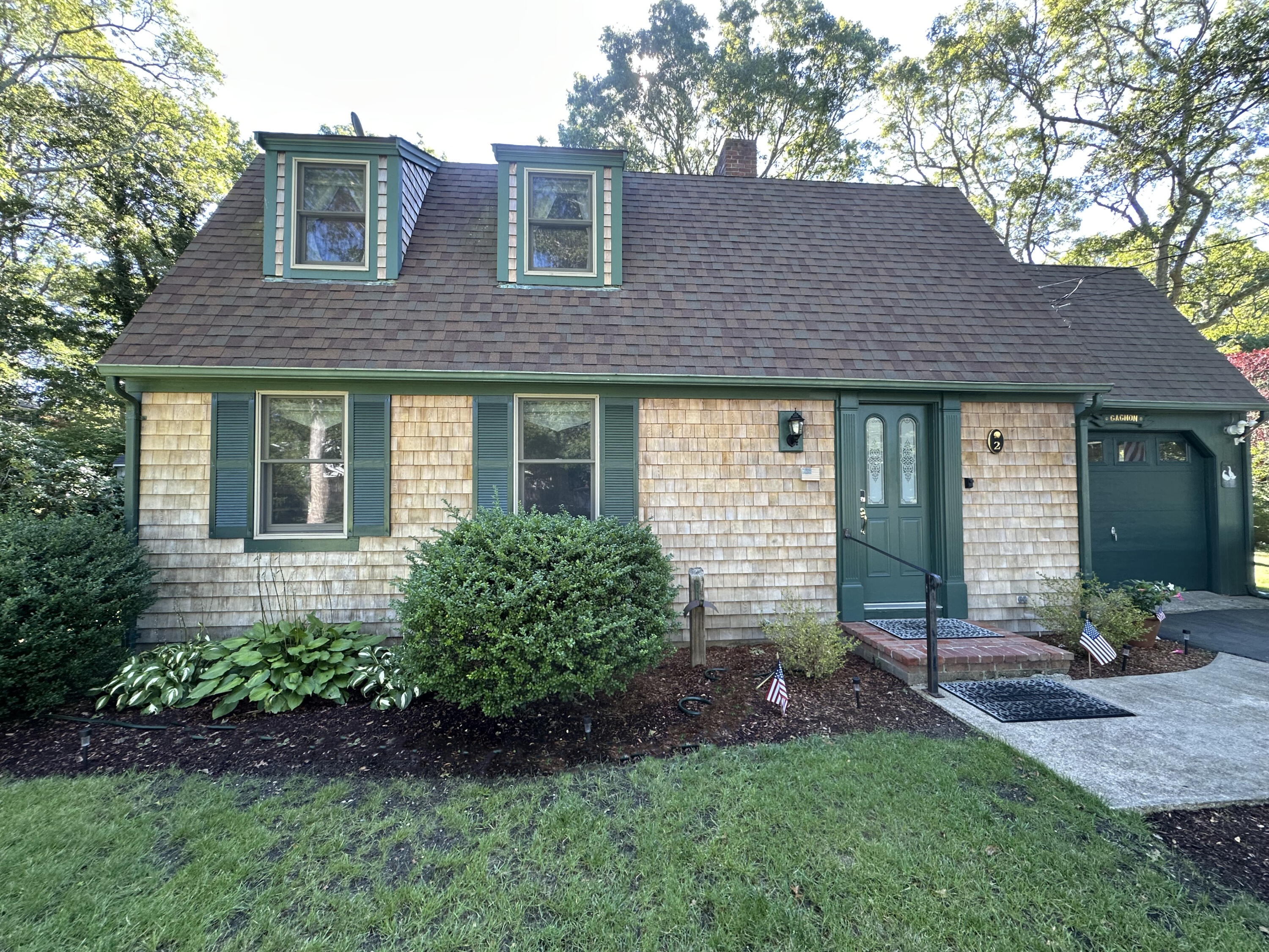 2 Longview Drive Centerville, MA 02632 - Photo 2 of 45 a front view of a house with a garden and porch