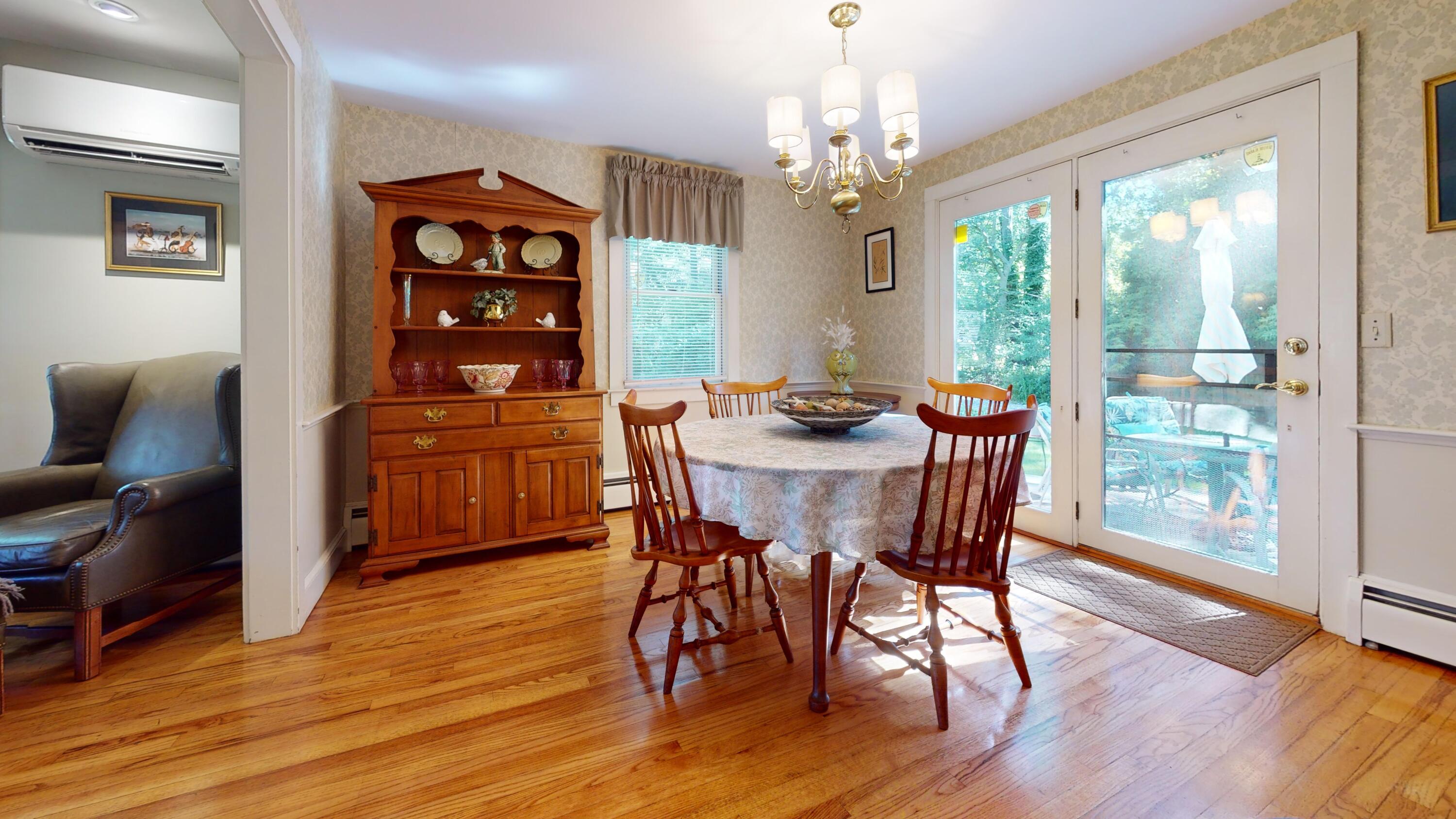 2 Longview Drive Centerville, MA 02632 - Photo 21 of 45 a dining room with wooden floor a chandelier a wooden table and chairs