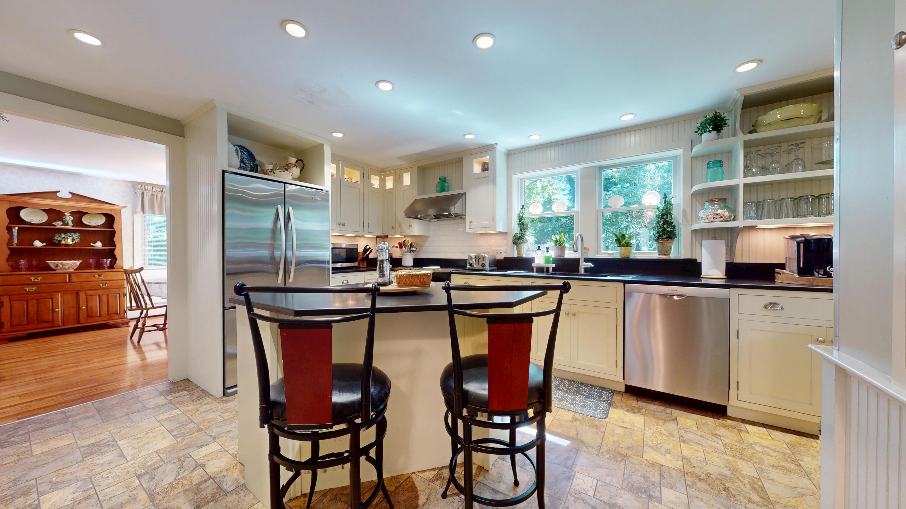 2 Longview Drive Centerville, MA 02632 - Photo 23 of 45 a kitchen with stainless steel appliances granite countertop a table chairs refrigerator and sink