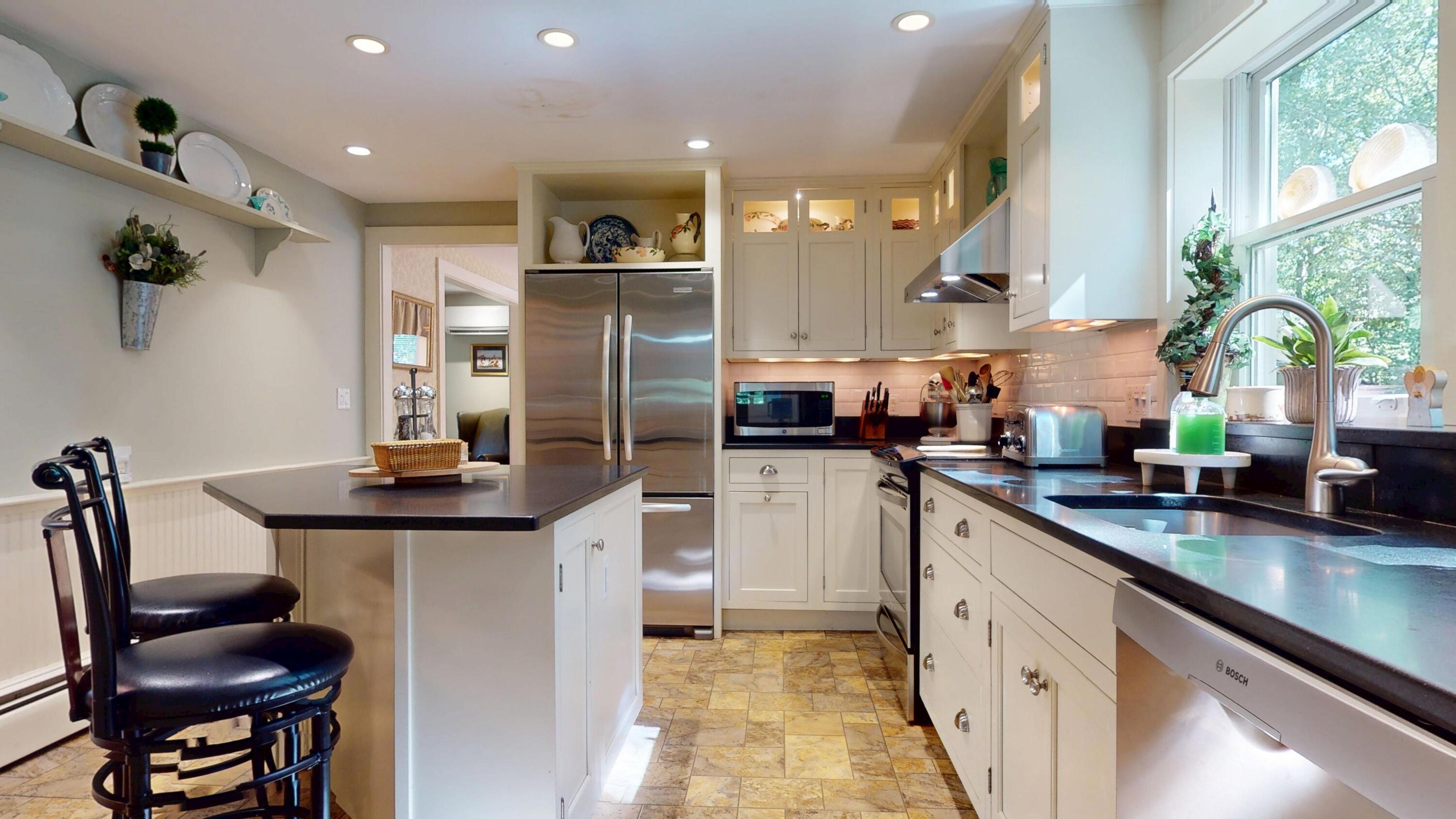 2 Longview Drive Centerville, MA 02632 - Photo 24 of 45 a kitchen with stainless steel appliances kitchen island granite countertop a sink refrigerator and cabinets