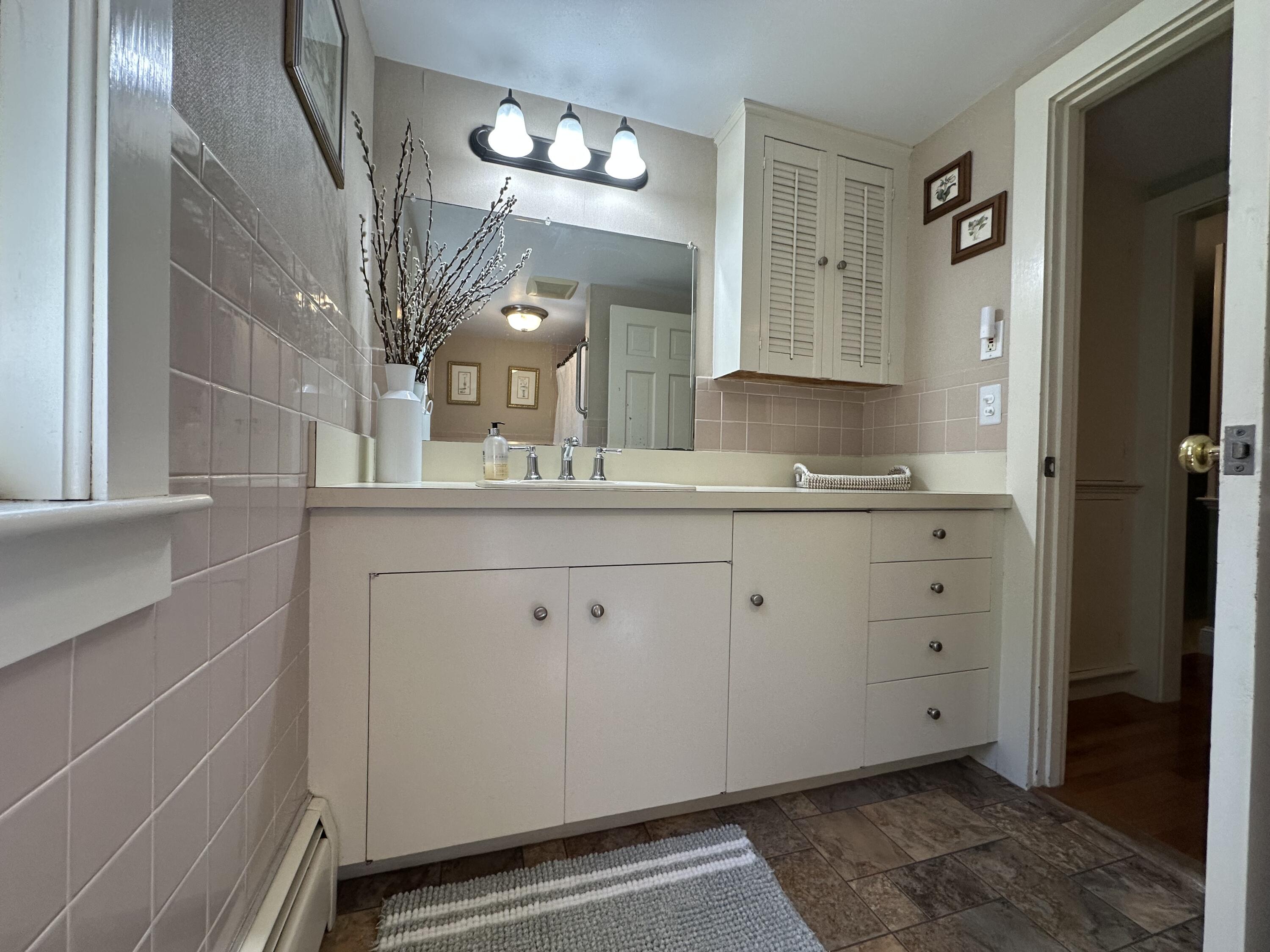 2 Longview Drive Centerville, MA 02632 - Photo 37 of 45 a bathroom with a double vanity sink and a mirror