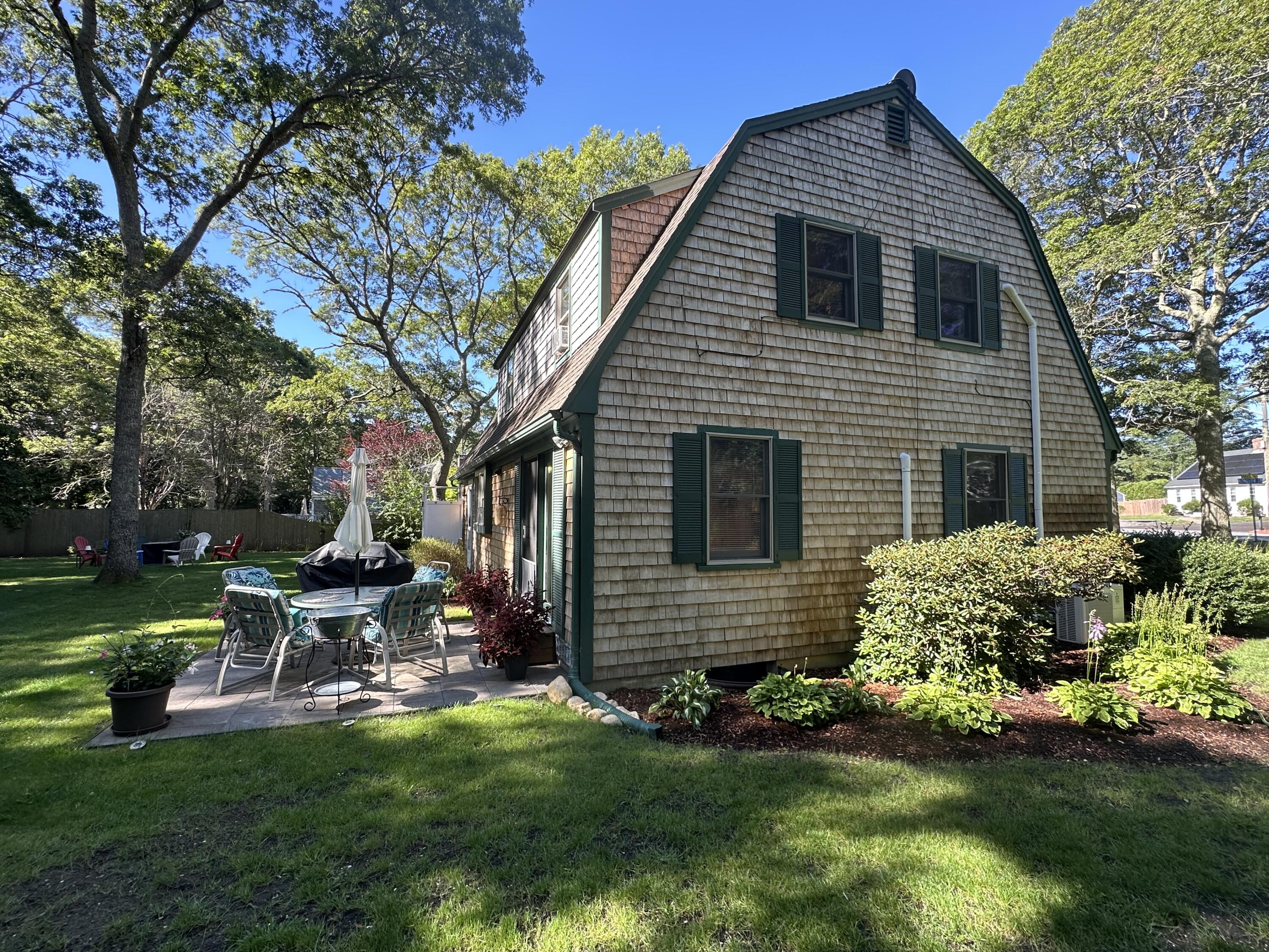 2 Longview Drive Centerville, MA 02632 - Photo 5 of 45 a view of a house with a yard chairs and a large tree