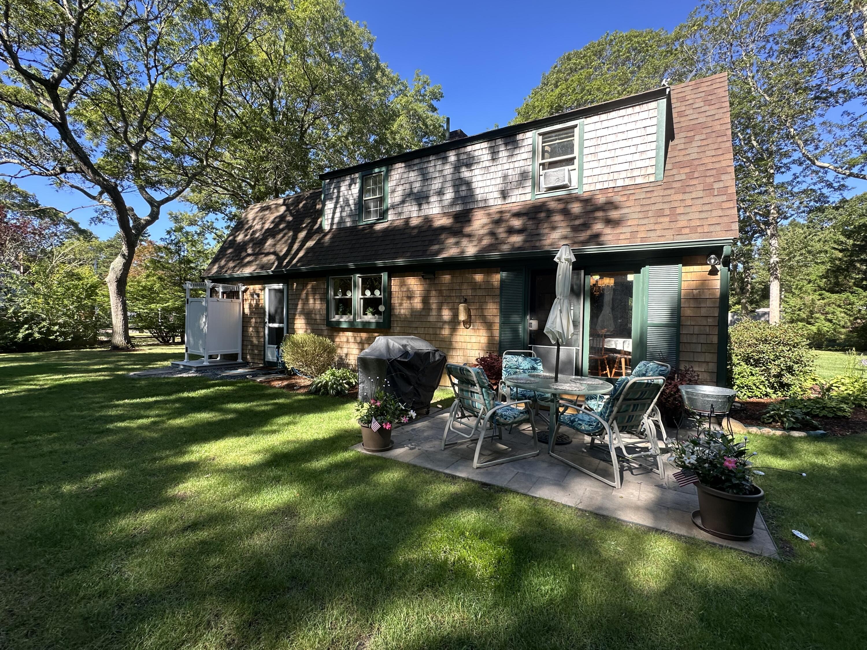 2 Longview Drive Centerville, MA 02632 - Photo 6 of 45 a view of a house with backyard sitting area and garden