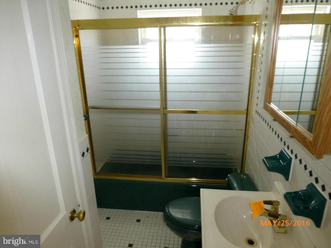 949 Middlesex Road Baltimore, MD 21221 - Photo 15 of 17 a bathroom with a sink a toilet and shower