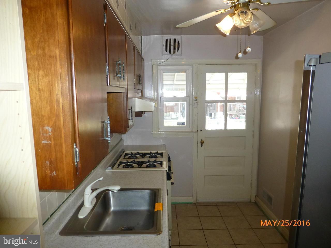 949 Middlesex Road Baltimore, MD 21221 - Photo 5 of 17 a kitchen with stainless steel appliances a refrigerator and a stove