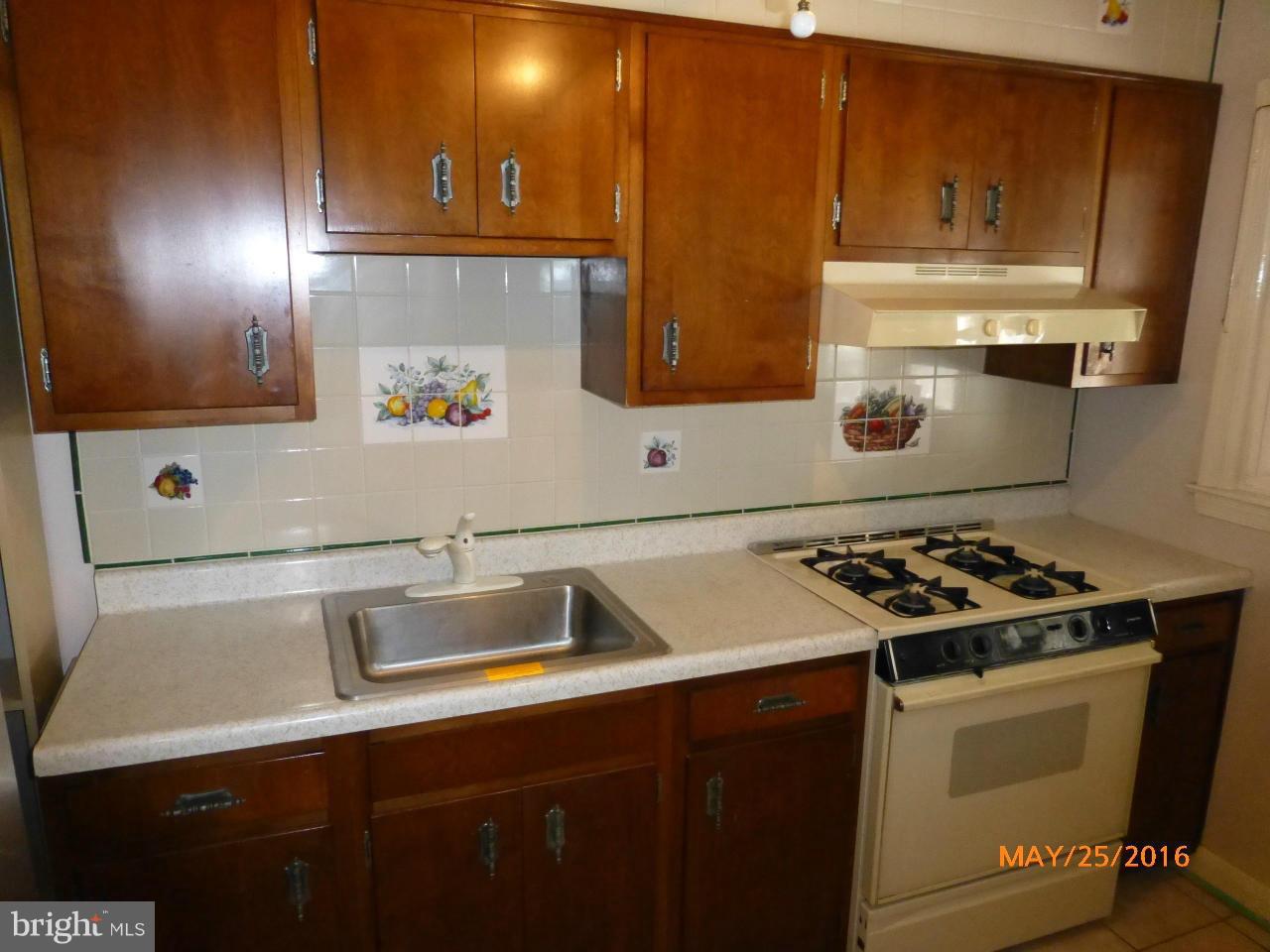 949 Middlesex Road Baltimore, MD 21221 - Photo 6 of 17 a kitchen with a sink a stove and cabinets