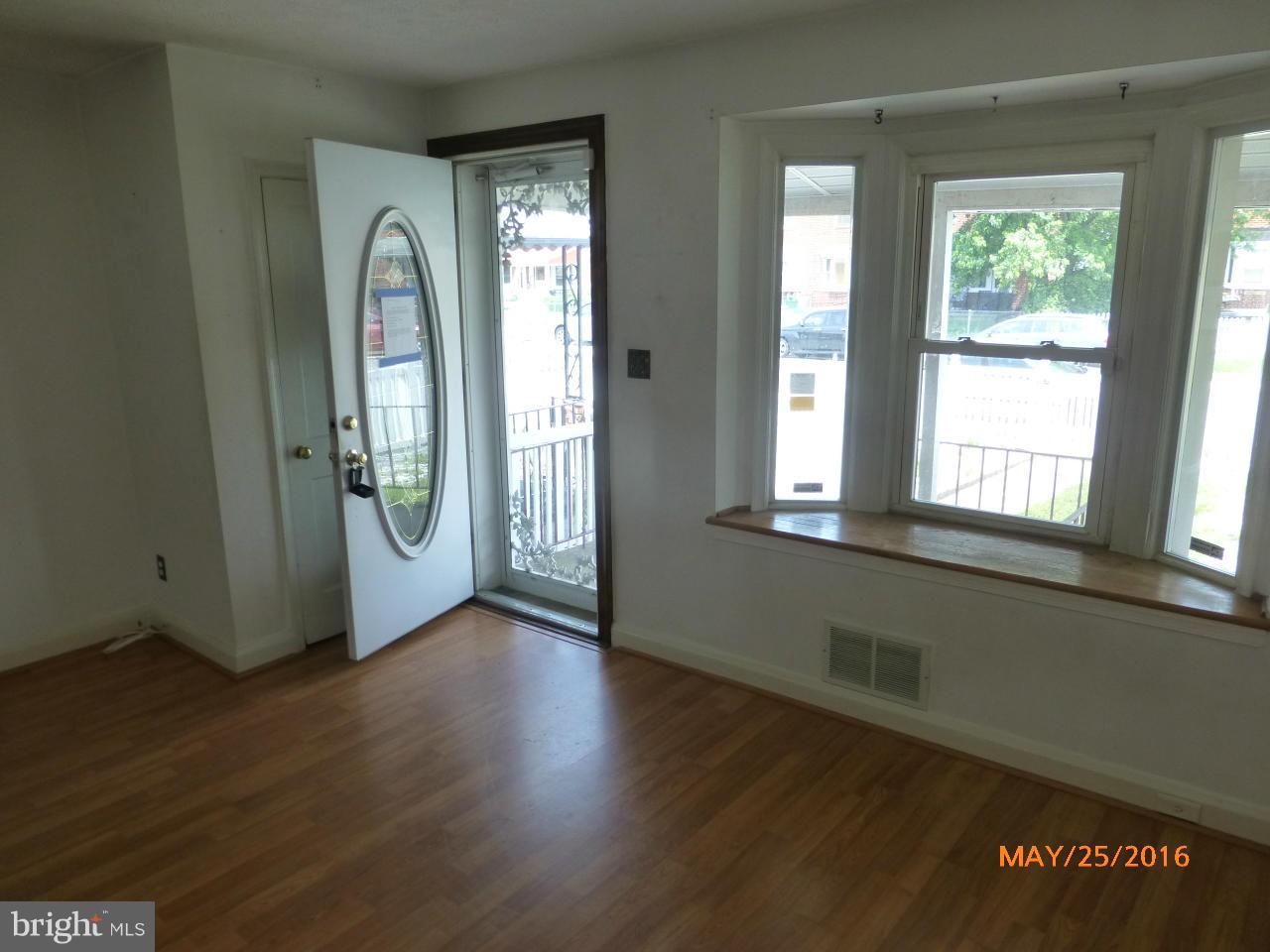 949 Middlesex Road Baltimore, MD 21221 - Photo 7 of 17 an empty room with wooden floor and windows