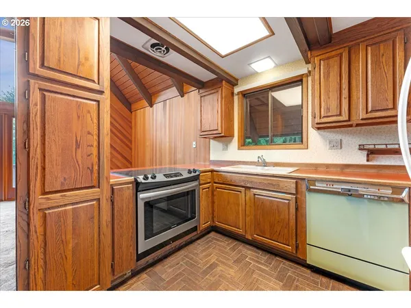 a kitchen with stainless steel appliances granite countertop a sink a stove and a microwave