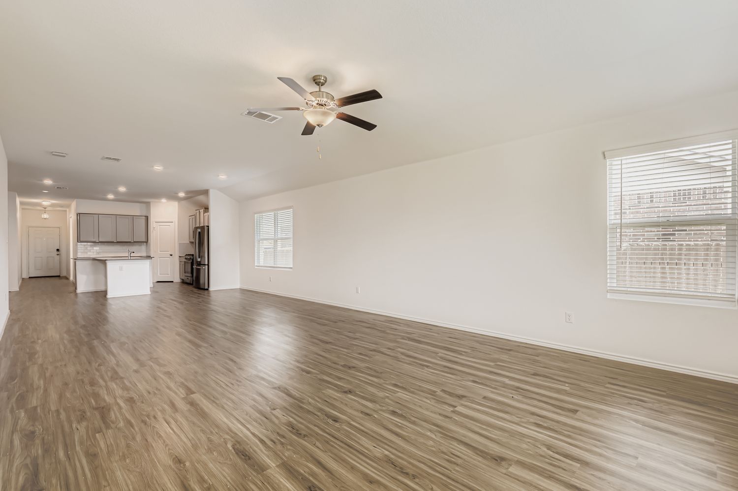 128 Concho Brook Bend Georgetown, TX 78626 - Photo 5 of 28 a view of empty room with wooden floor and windows