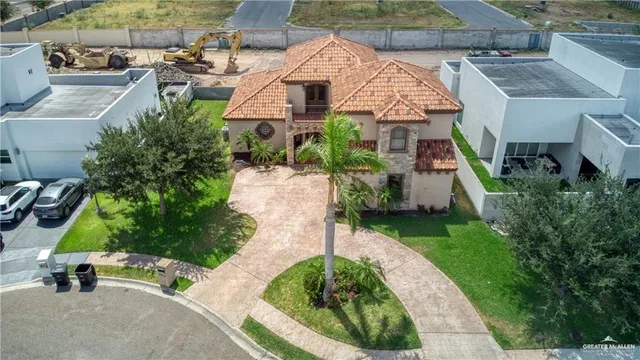 an aerial view of a house with a garden and plants