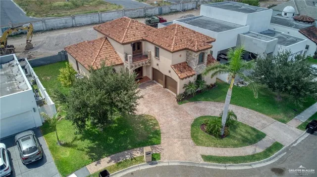 an aerial view of a house with garden space and a patio