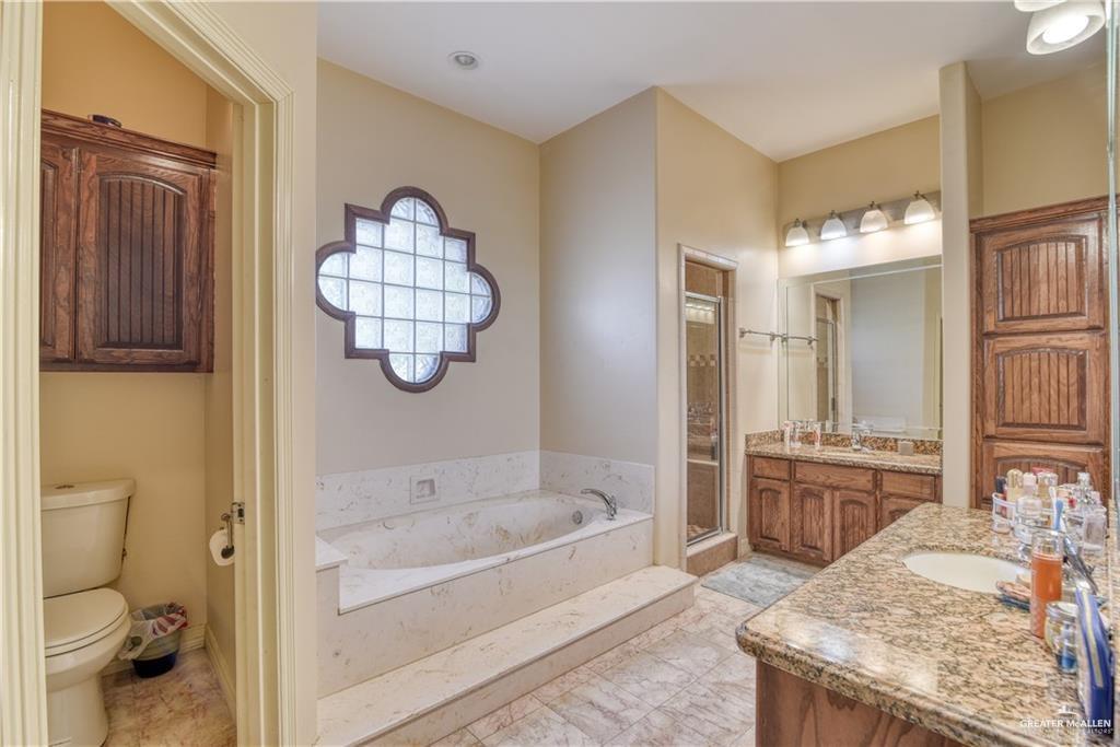 2016 South 48th Street McAllen, TX 78503 - Photo 7 of 9 a bathroom with a granite countertop sink a toilet and bathtub