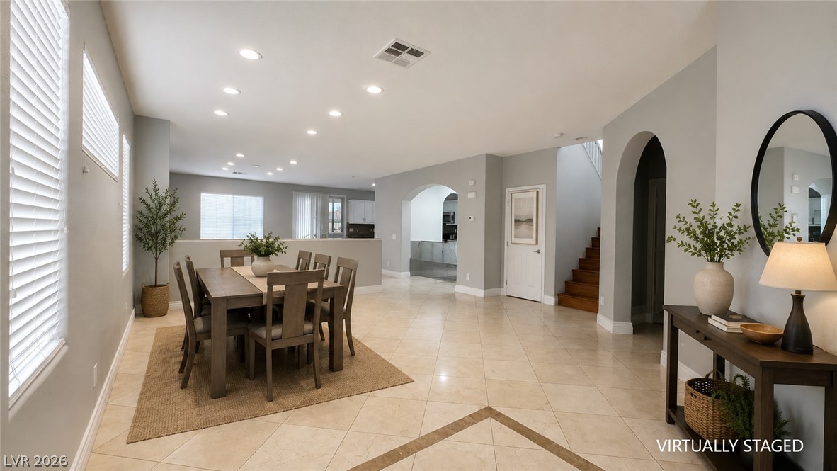 87 Tall Ruff Drive Las Vegas, NV 89148 - Photo 42 of 71 An inviting open-concept dining area and foyer with elegant tile flooring and graceful arched entryways.
