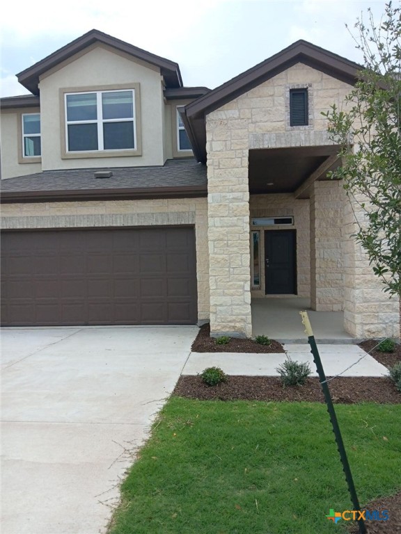 6230 Marsh Lane Buda, TX 78610 - Photo 1 of 15 a front view of a house with a yard