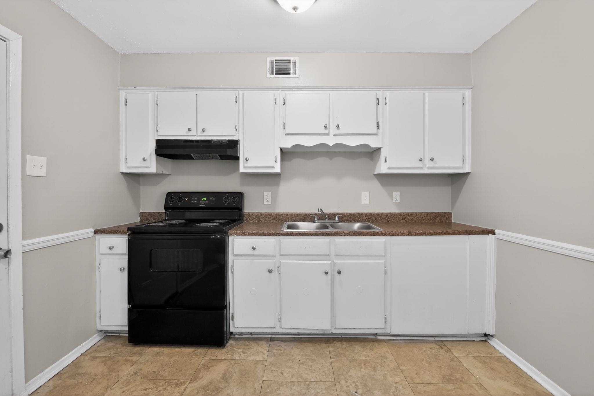 2449 Labonte Drive Memphis, TN 38127 - Photo 14 of 30 a kitchen with stainless steel appliances granite countertop a stove and a refrigerator