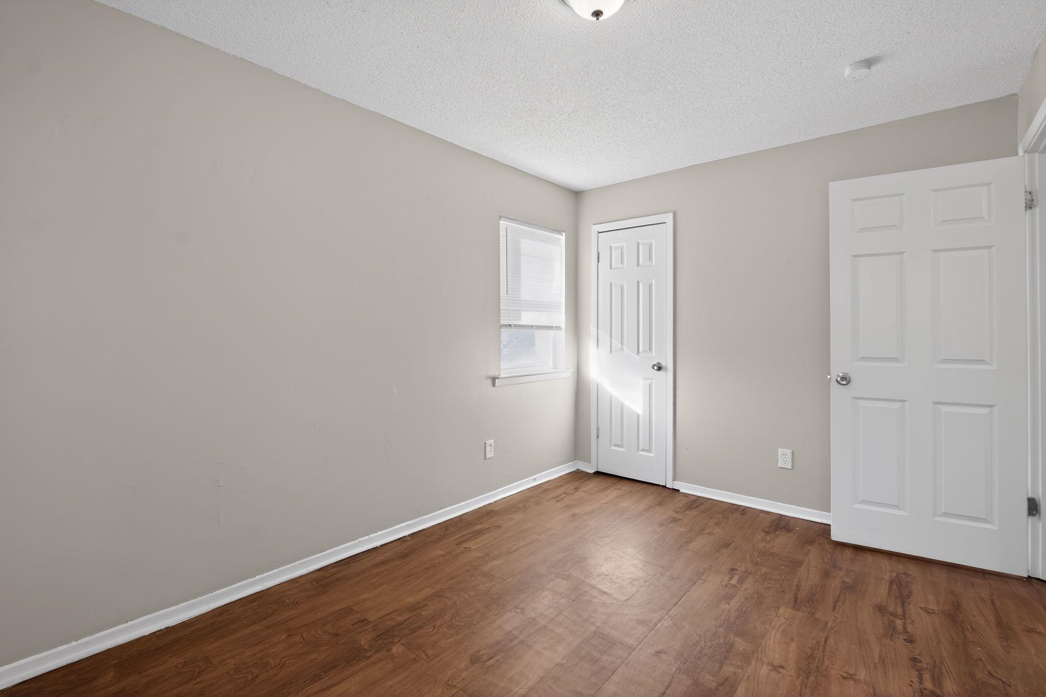 2449 Labonte Drive Memphis, TN 38127 - Photo 20 of 30 a view of an empty room with wooden floor and closet