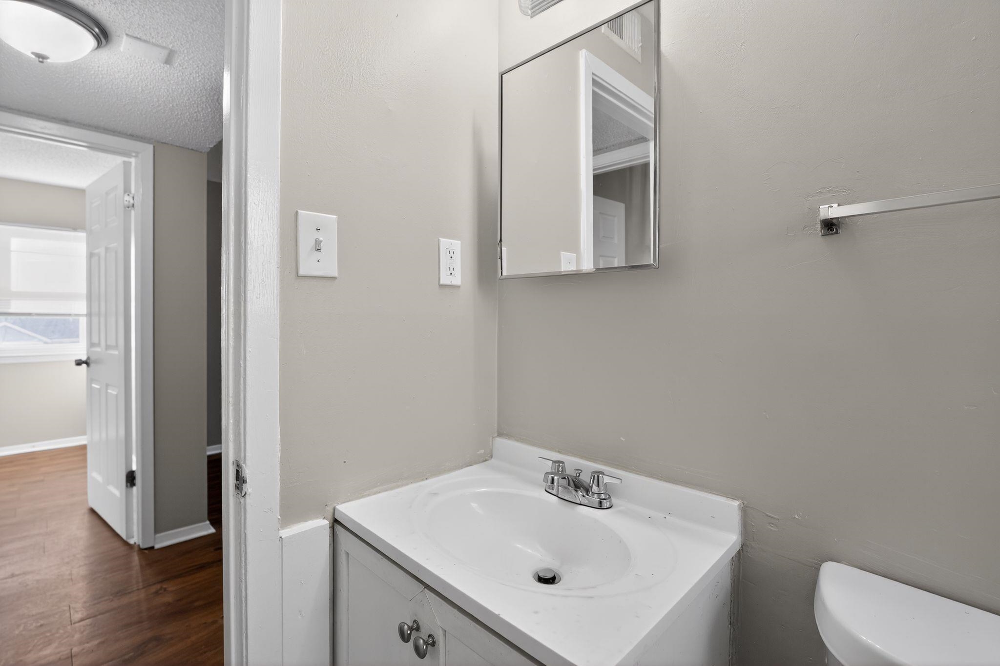 2449 Labonte Drive Memphis, TN 38127 - Photo 21 of 30 a bathroom with a sink a toilet and mirror