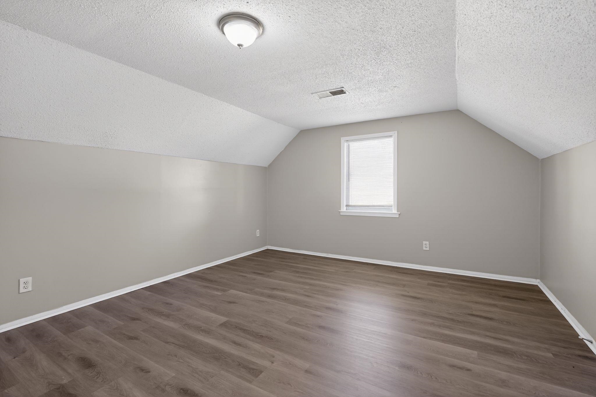2449 Labonte Drive Memphis, TN 38127 - Photo 27 of 30 an empty room with wooden floor and windows