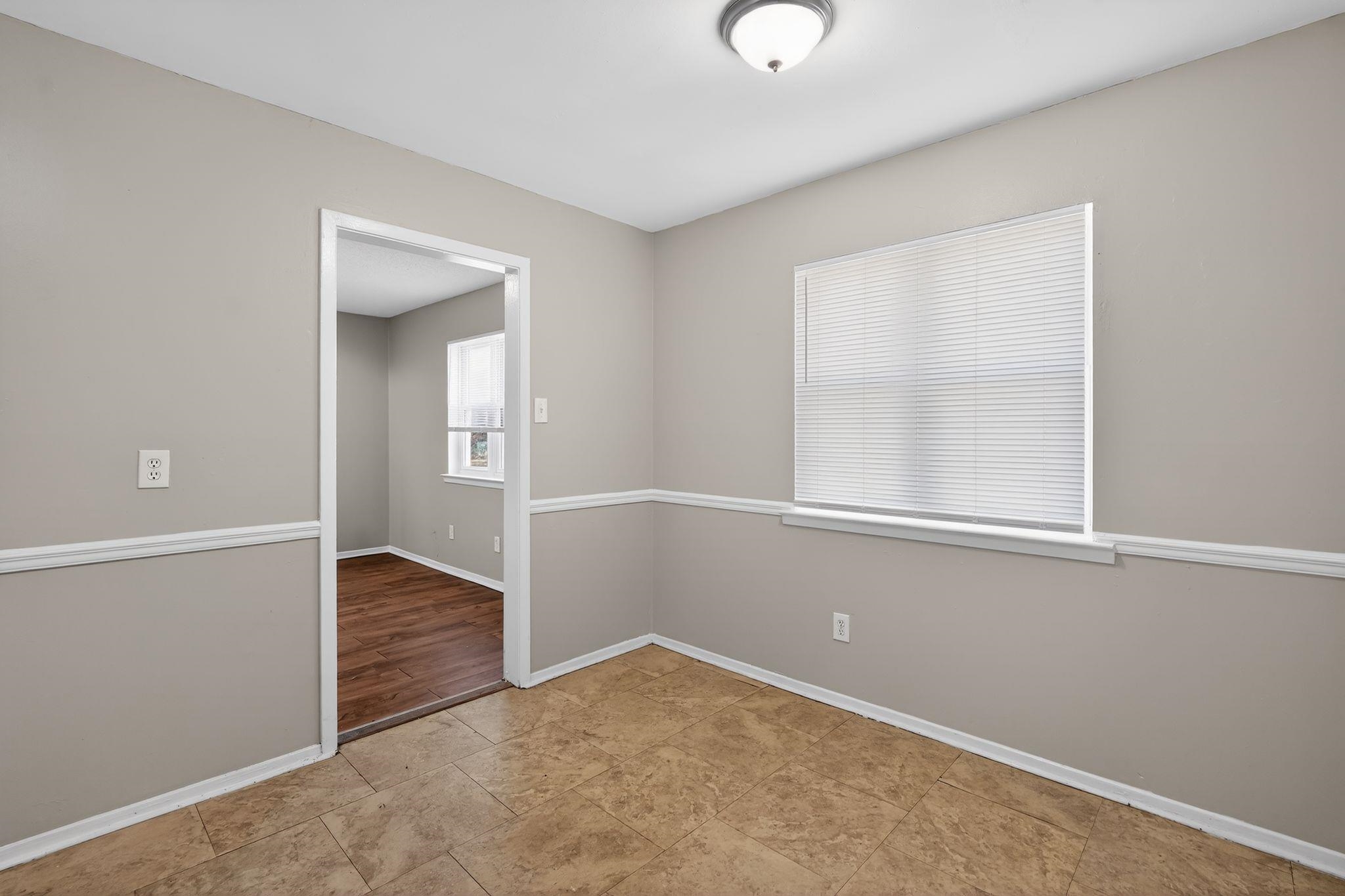 2449 Labonte Drive Memphis, TN 38127 - Photo 7 of 30 an empty room with wooden floor and windows