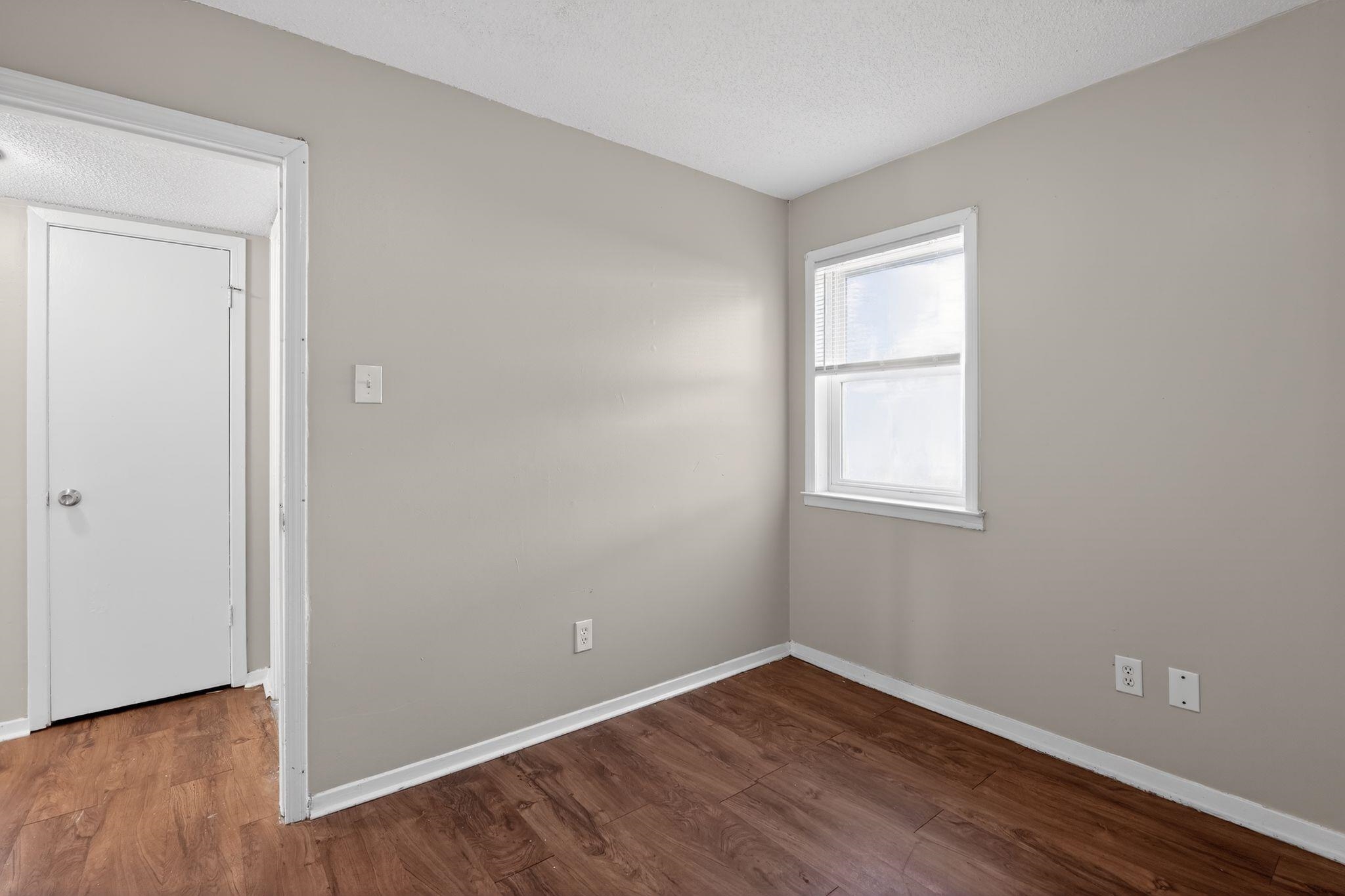 2449 Labonte Drive Memphis, TN 38127 - Photo 8 of 30 a view of an empty room with wooden floor and a window