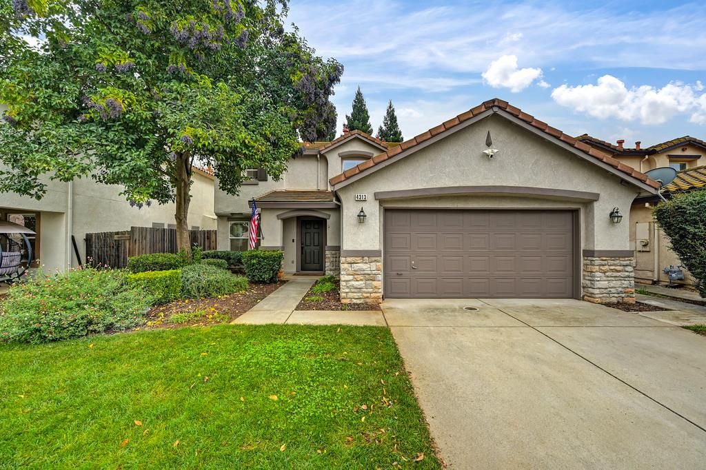 a front view of a house with a yard and garage