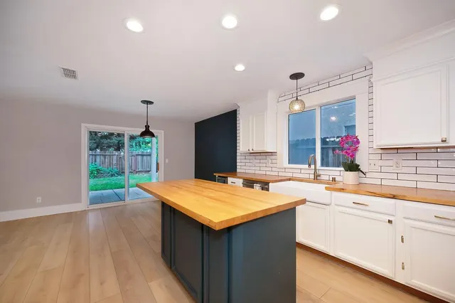 a kitchen with stainless steel appliances a stove refrigerator sink and cabinets