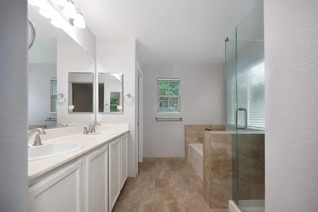 a bathroom with 2 sink and a mirror