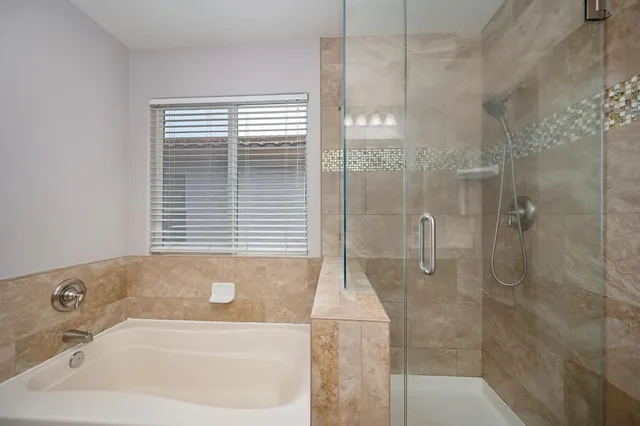 an empty room with ceiling fan and window