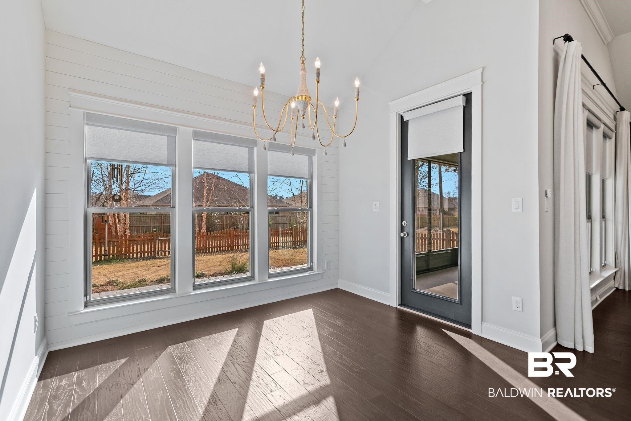 31654 Canopy Loop Daphne, AL 36527 - Photo 25 of 64 Unfurnished dining area featuring suspended lighting, dark wood-style flooring, and vaulted ceiling