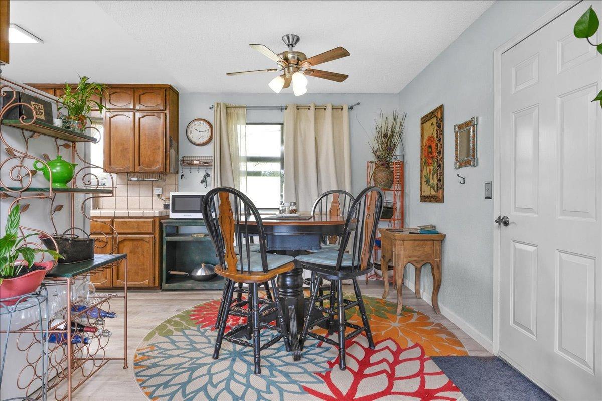 26982 Twin Ponds Road Clovis, CA 93619 - Photo 12 of 48 a view of a dining room with furniture window and wooden floor