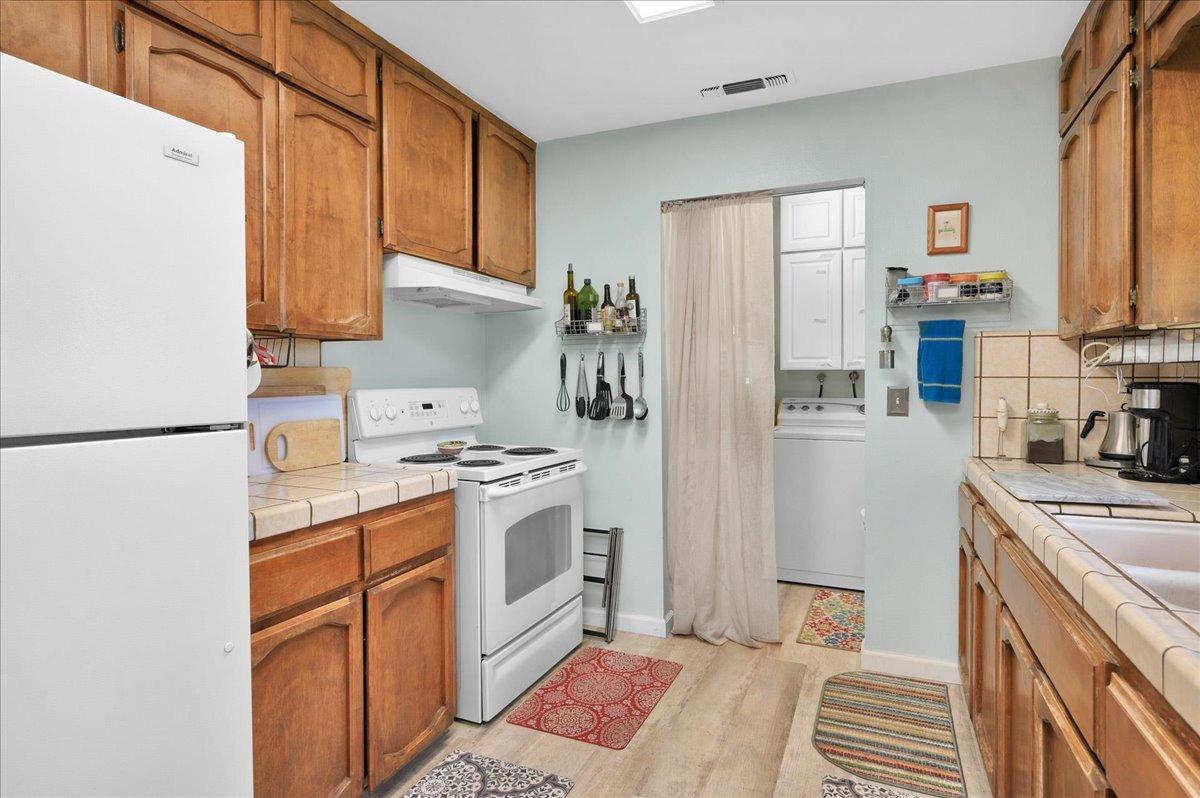 26982 Twin Ponds Road Clovis, CA 93619 - Photo 15 of 48 a kitchen with stainless steel appliances granite countertop a refrigerator stove and sink