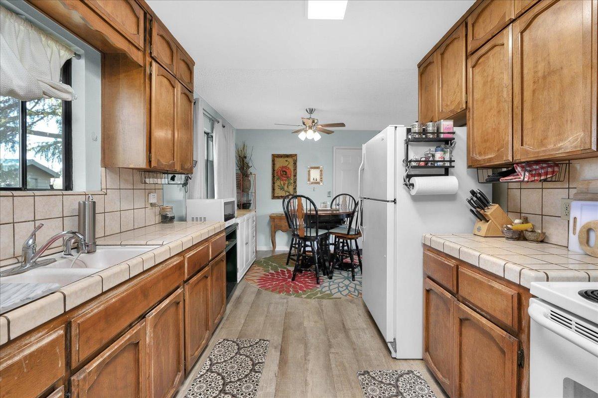 26982 Twin Ponds Road Clovis, CA 93619 - Photo 16 of 48 a kitchen with granite countertop lots of counter top space and stainless steel appliances