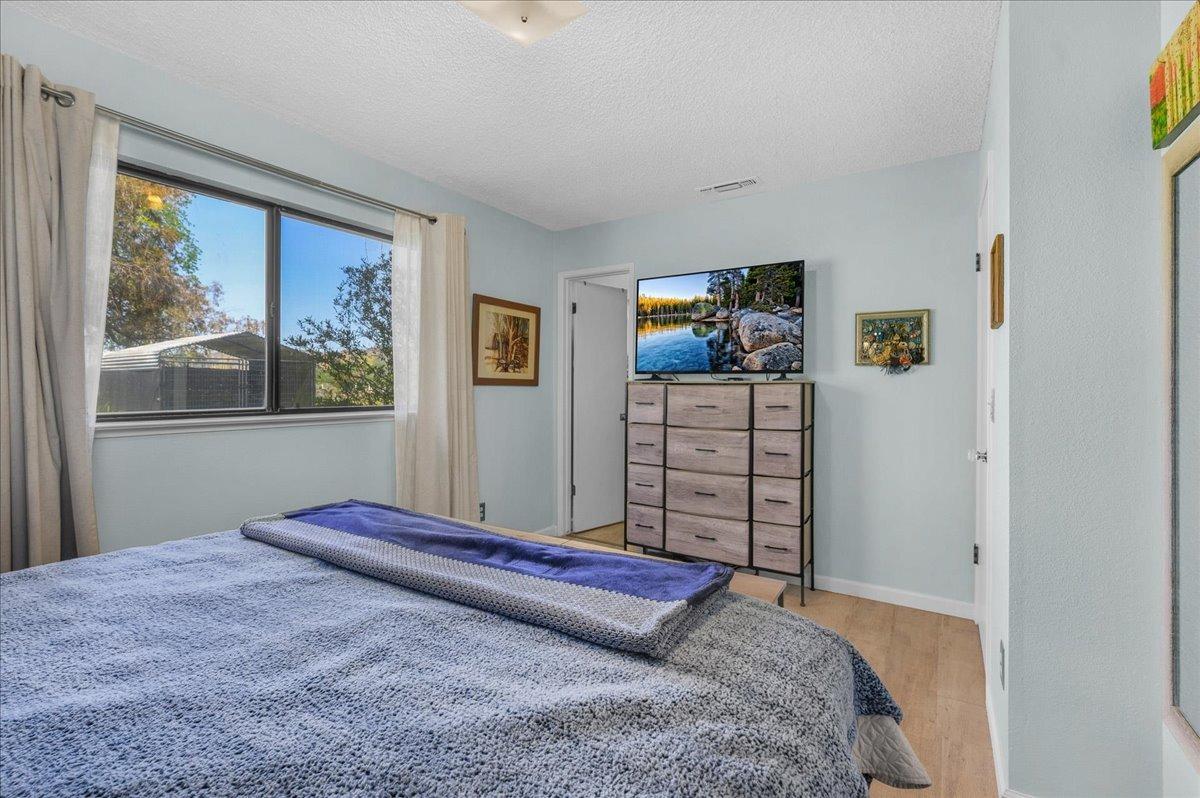 26982 Twin Ponds Road Clovis, CA 93619 - Photo 25 of 48 a bedroom with a bed and wooden floor