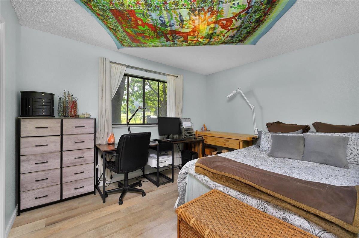 26982 Twin Ponds Road Clovis, CA 93619 - Photo 27 of 48 a bedroom with a bed and wooden floor