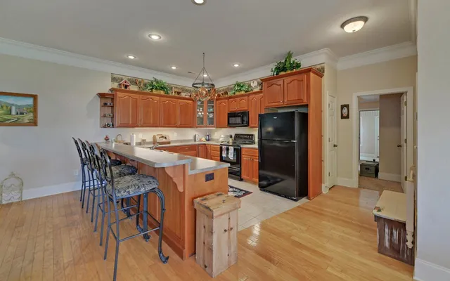 a kitchen with stainless steel appliances granite countertop a stove and a microwave