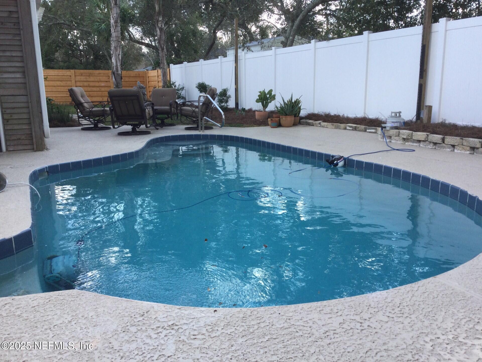 340 Shamrock Road St. Augustine, FL 32086 - Photo 11 of 21 a view of a swimming pool with a sitting area