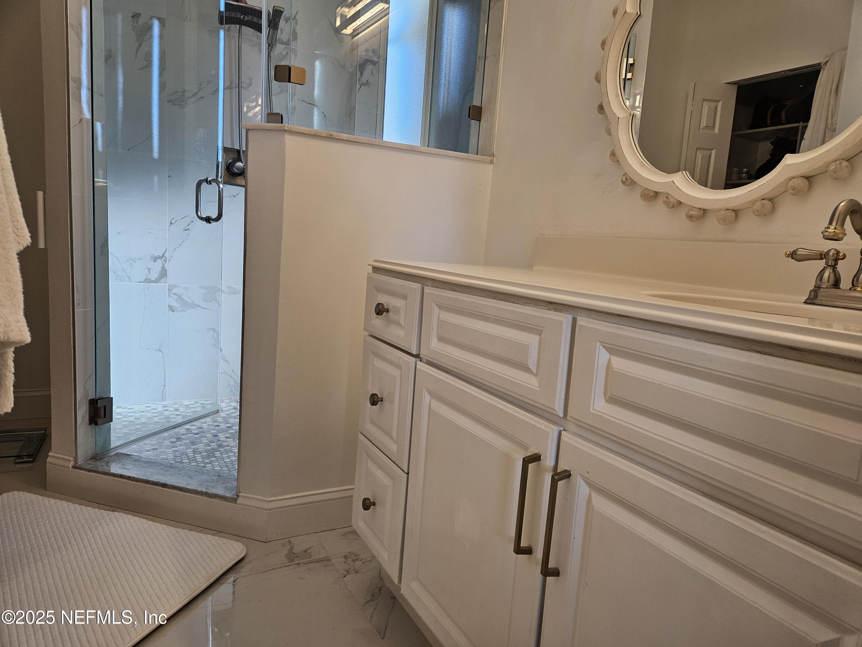 340 Shamrock Road St. Augustine, FL 32086 - Photo 16 of 21 a bathroom with a mirror and a shower