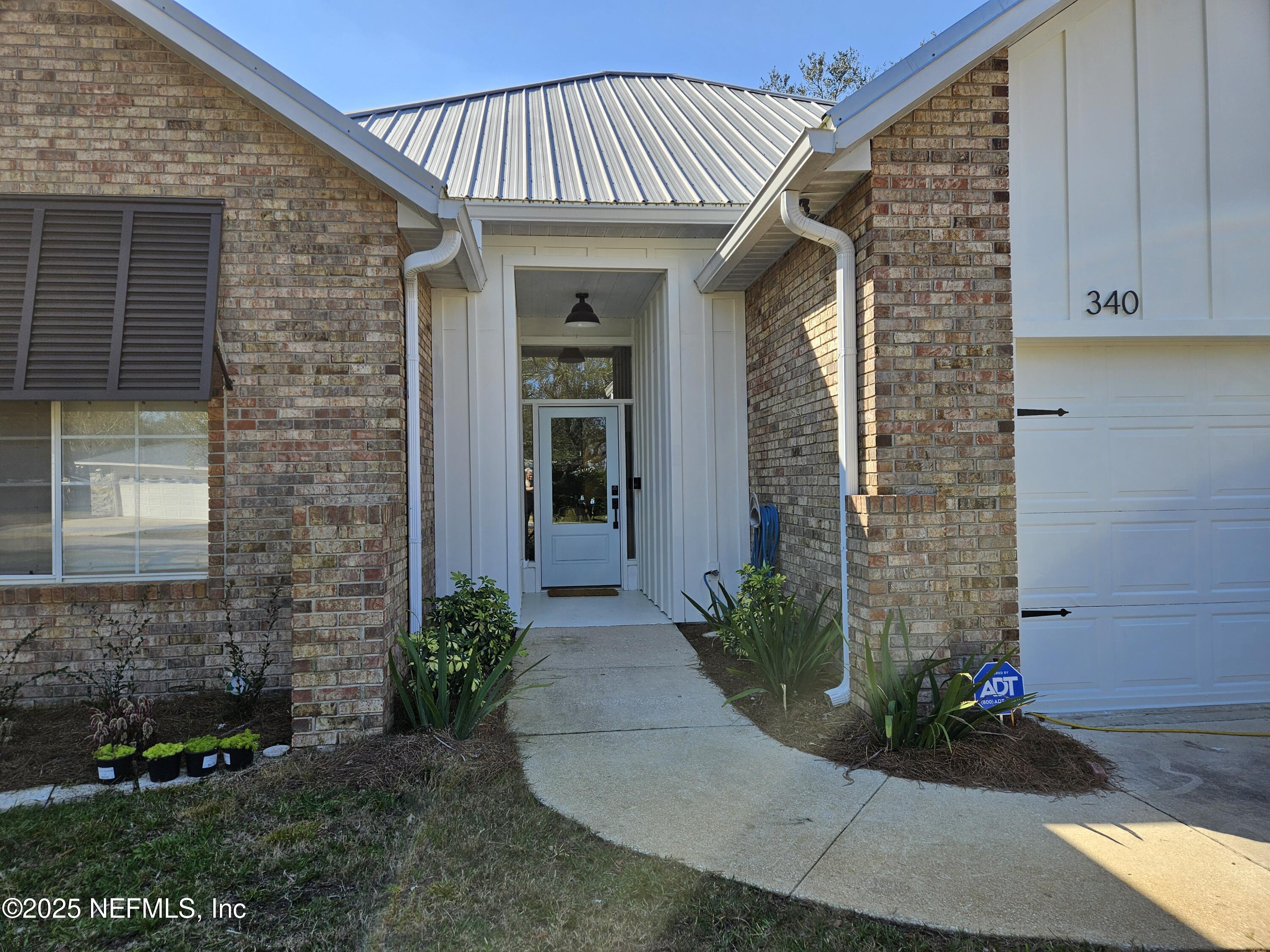 340 Shamrock Road St. Augustine, FL 32086 - Photo 8 of 21 a front view of a house with a garden