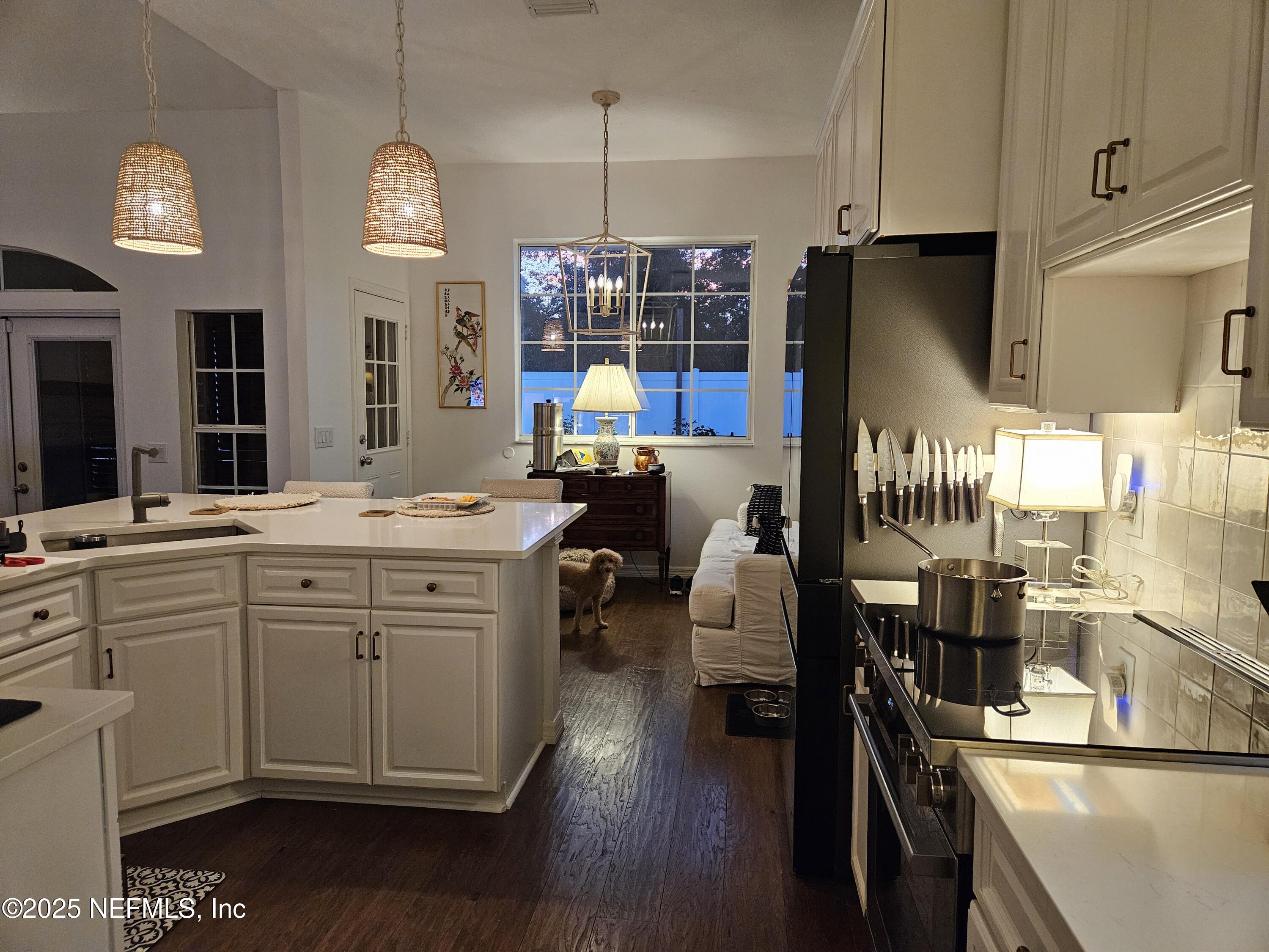 340 Shamrock Road St. Augustine, FL 32086 - Photo 9 of 21 a kitchen that has a lot of cabinets a sink and appliances in it