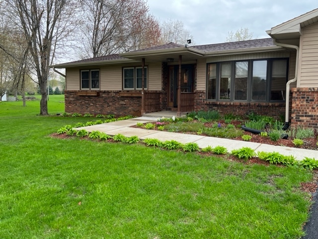 5833 South Skare Road Rochelle, IL 61068 - Photo 2 of 41 a view of a house with a yard and plants