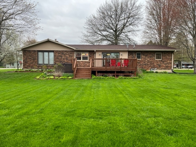 5833 South Skare Road Rochelle, IL 61068 - Photo 32 of 41 a view of a yard in front of a house with large windows