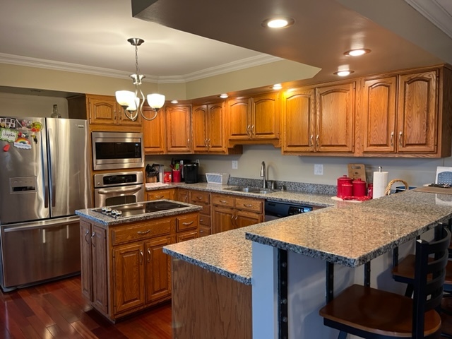 5833 South Skare Road Rochelle, IL 61068 - Photo 5 of 41 a kitchen with stainless steel appliances granite countertop a sink refrigerator stove dining table and chairs