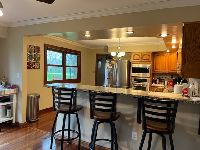 5833 South Skare Road Rochelle, IL 61068 - Photo 9 of 41 a kitchen with a table chairs sink and cabinets