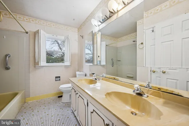 a bathroom with a tub sink and mirror