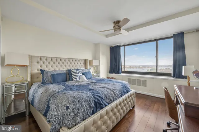 a bedroom with a large bed and a large window