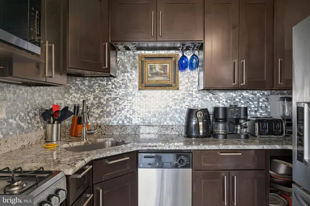 a kitchen with granite countertop a stove and a sink