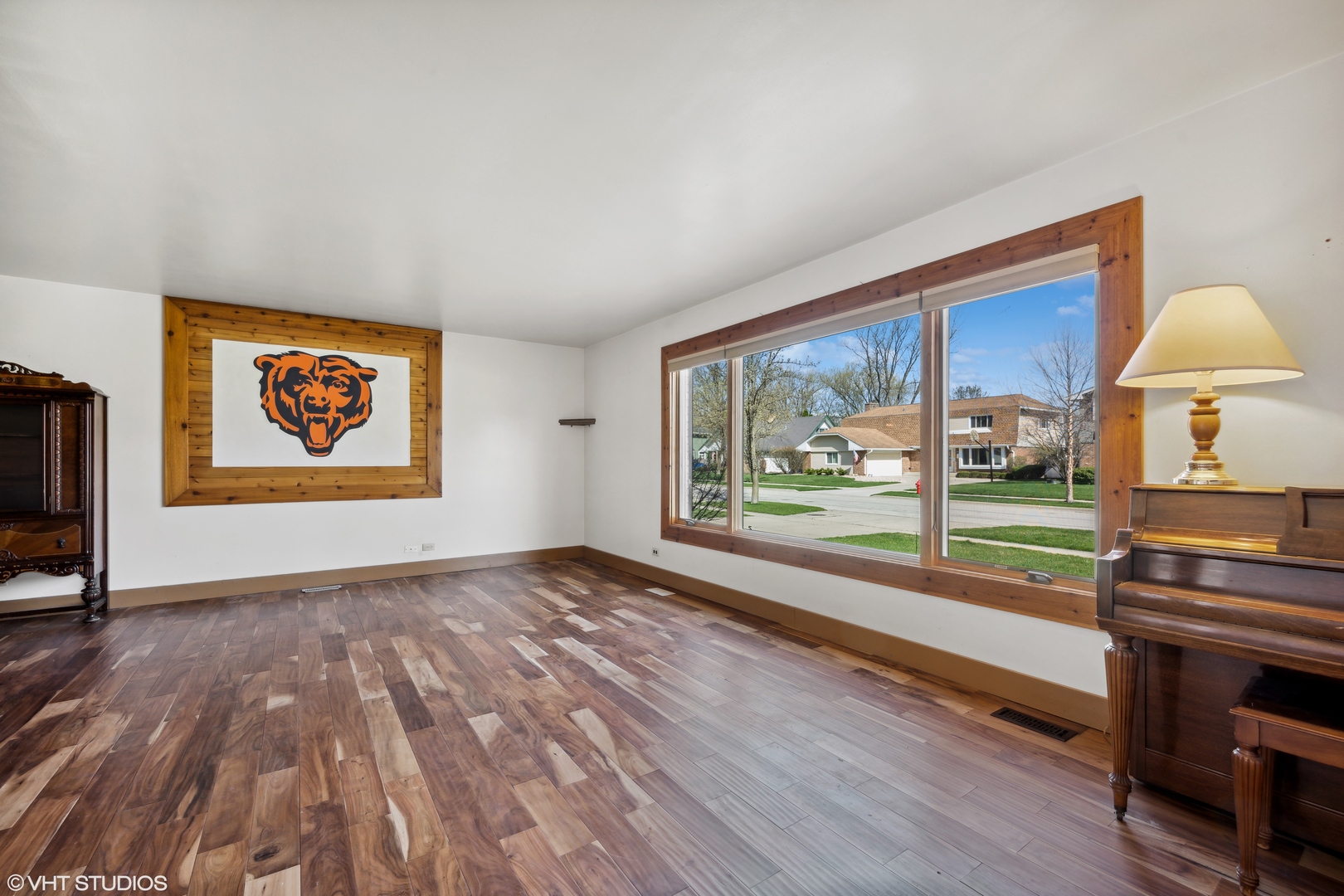 4507 Gettysburg Drive Rolling Meadows, IL 60008 - Photo 5 of 25 a view of an empty room with window a ceiling fan and wooden floor